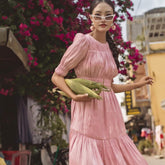 Silk midi dress with ruched bodice, puff sleeves, and flared tiered skirt